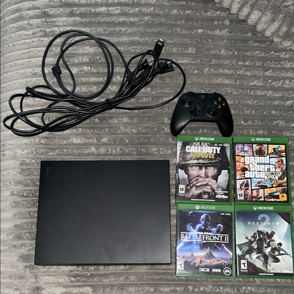 Black Xbox One X Console with Slim Design and Popular Game Selection